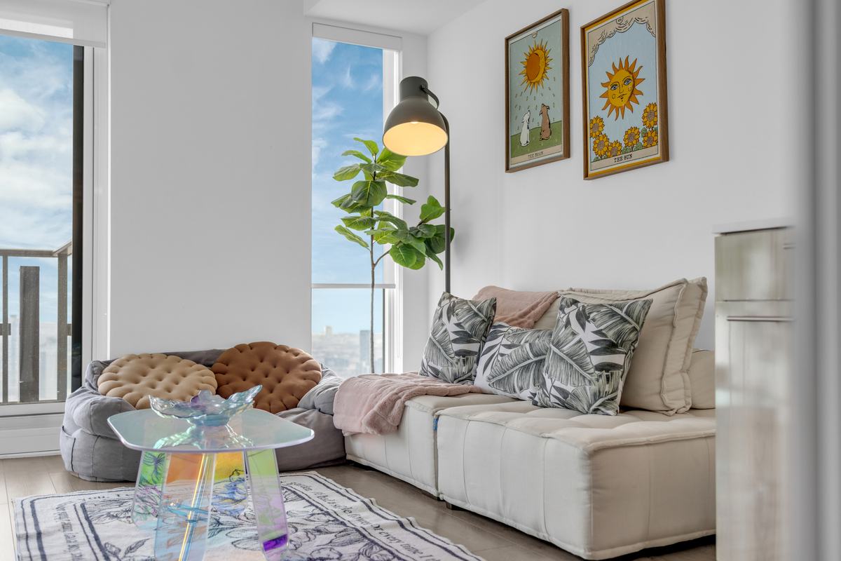 Sunlit living room with a low sofa and floor-to-ceiling windows