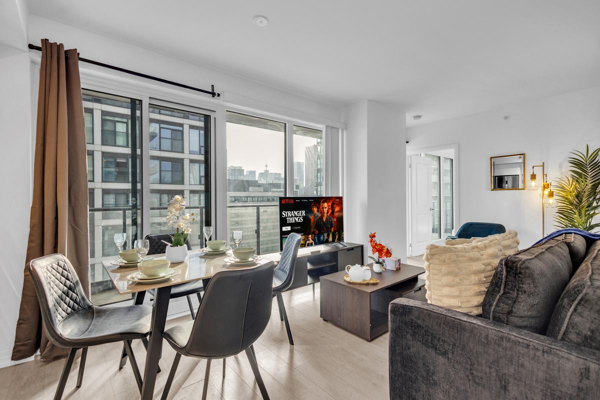 Dining table beside the windows with the city beyond