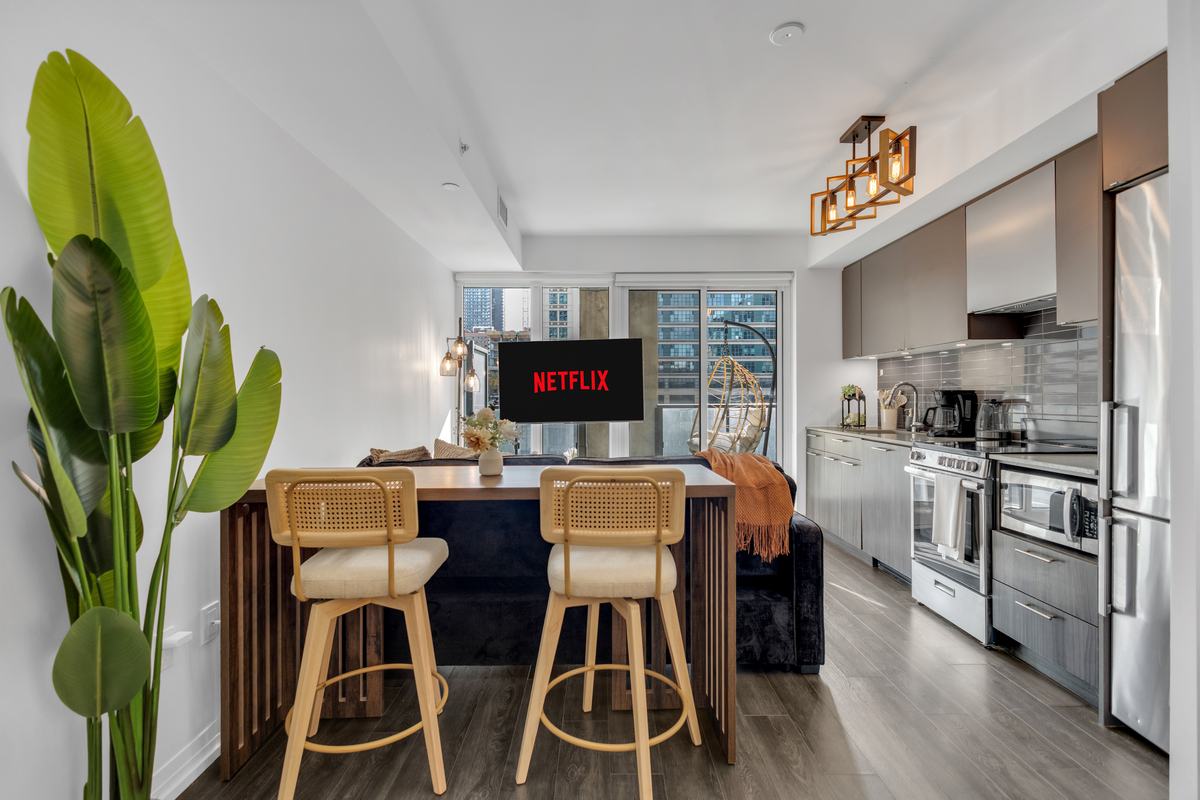 Open kitchen with breakfast-bar seating and a balcony chair