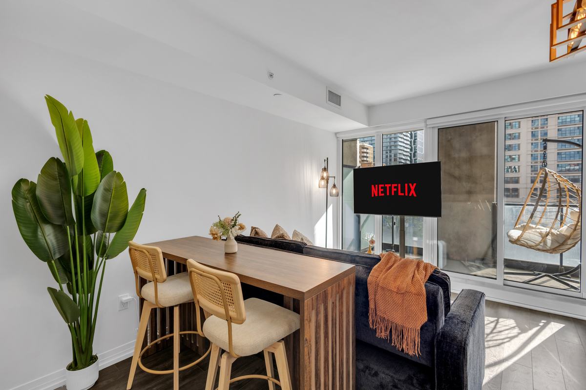 Living room with sofa, balcony access and city views