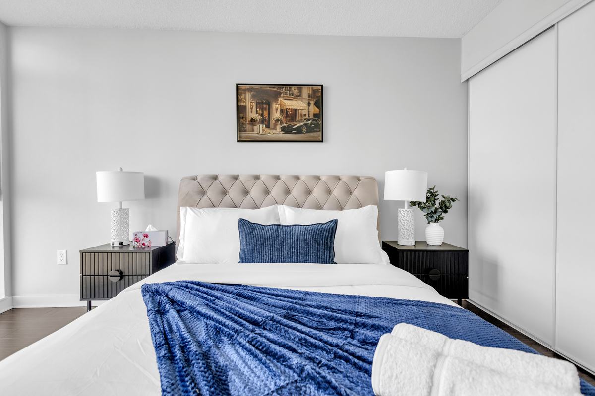 Bedroom with an upholstered headboard and bedside lamps