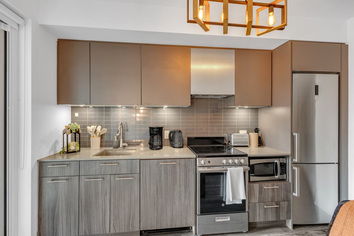 Kitchen counter with kettle, coffee maker and utensils