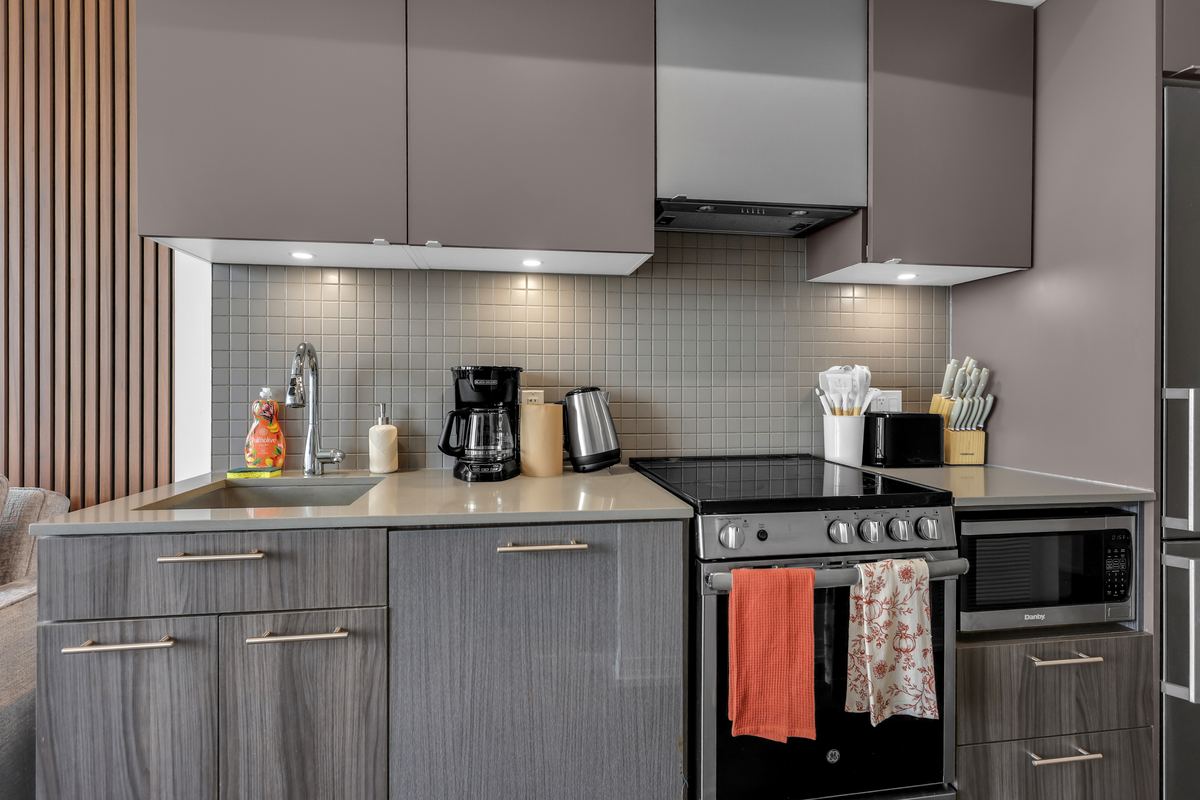 Kitchen with stainless appliances, kettle, coffee maker and knife block