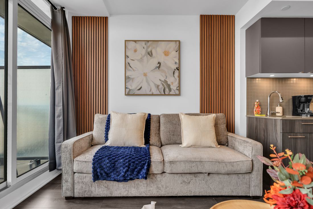 Kitchen opening onto a living room with a bedroom visible beyond